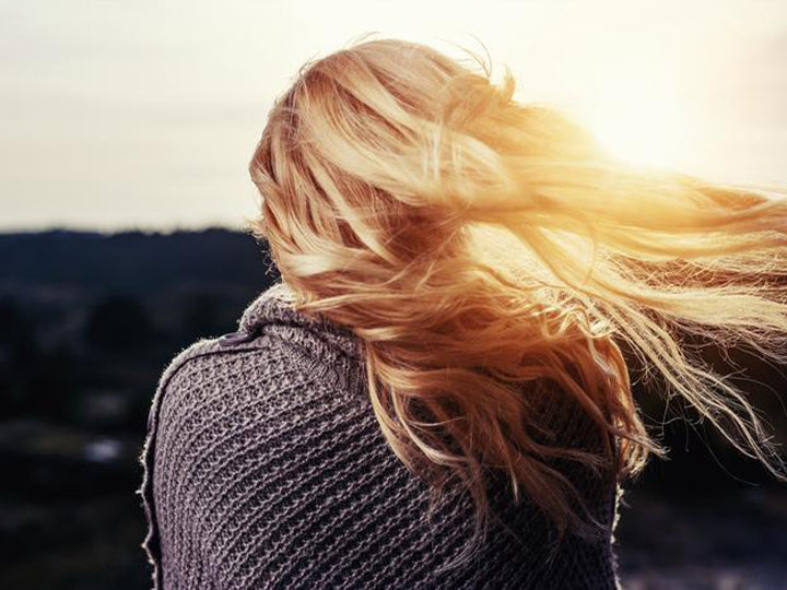 Läusefreie Haare einer Frau wehen im Wind